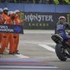 A view of workers prompting MotoGP's Championship racer to turn right
