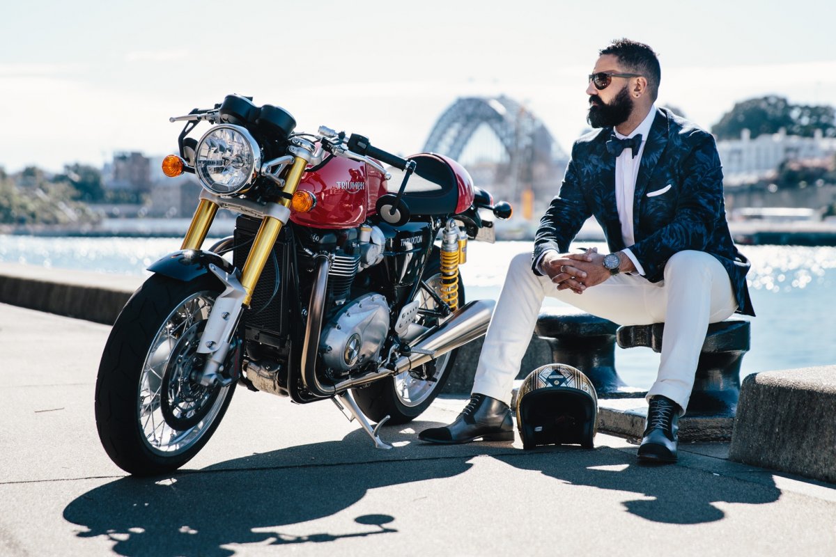 A view of the Distinguished Gentleman's Ride founder Mark Hawwa, next to his motorcycle