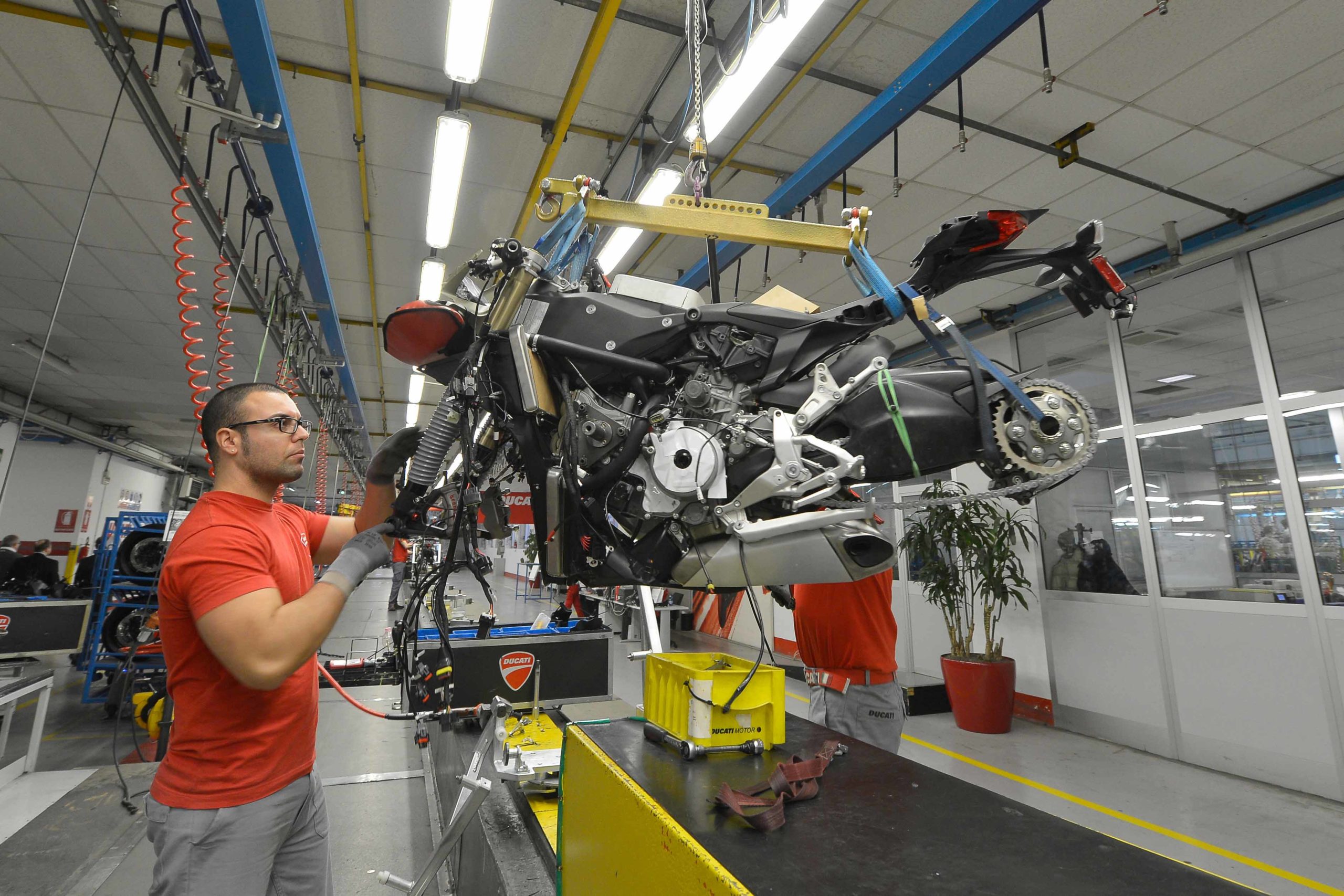 A worker toiling away at a Ducati bike in the creation process