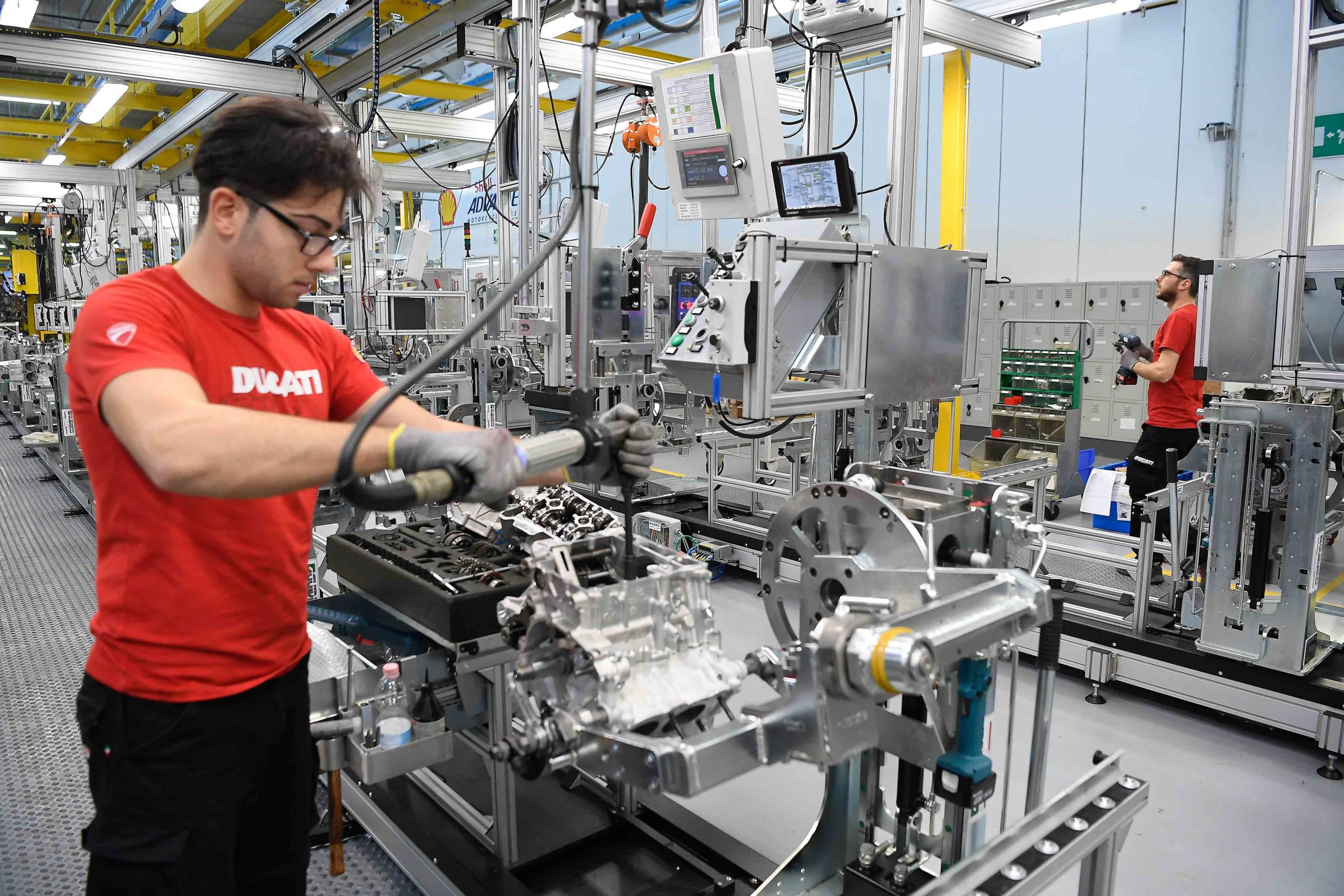 A worker toiling away at a Ducati bike in the creation process