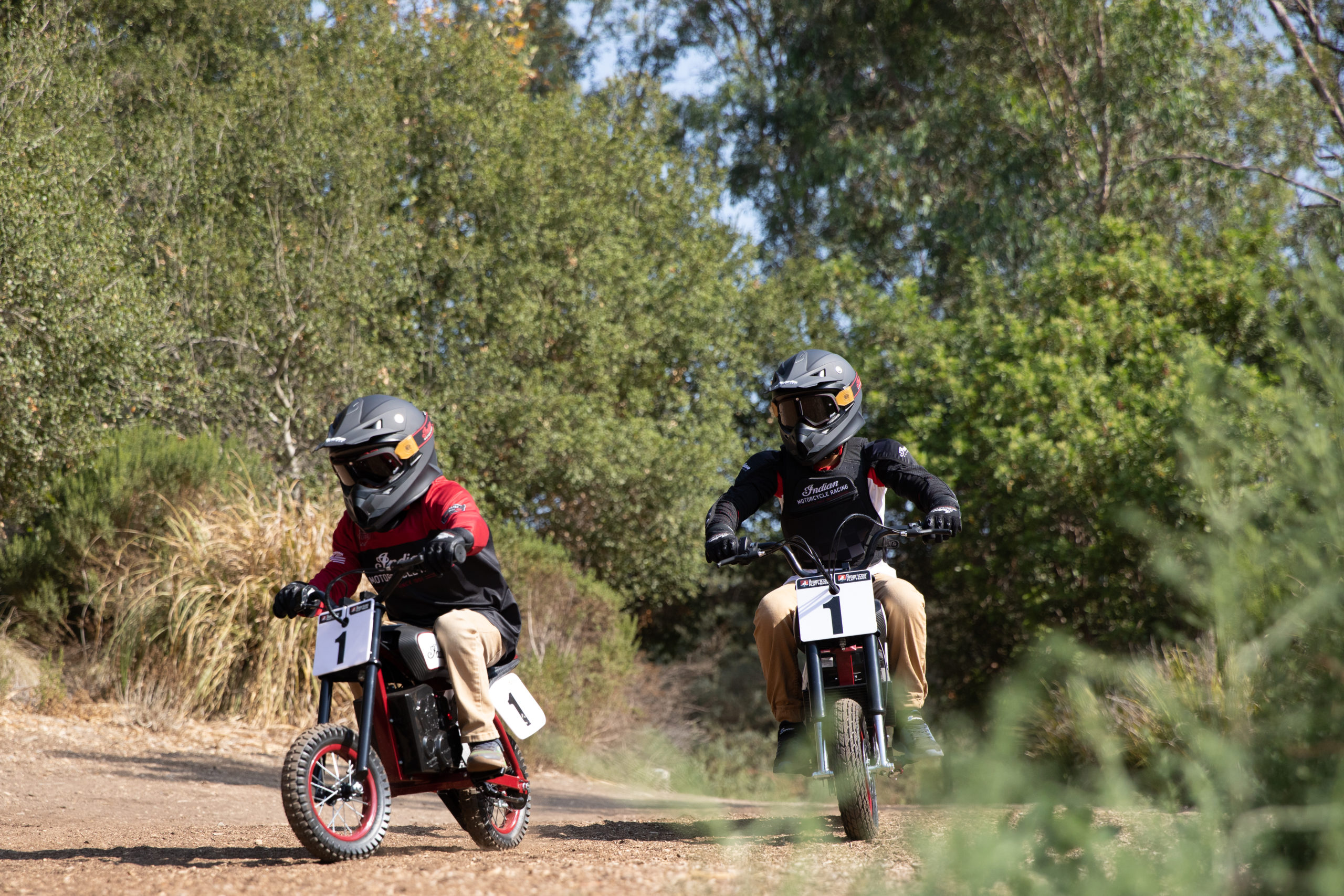 two young riders trying out the new sFTR Mini motorcycles from Indian Motorcycles - an electric-youth bike available to the smaller riding community