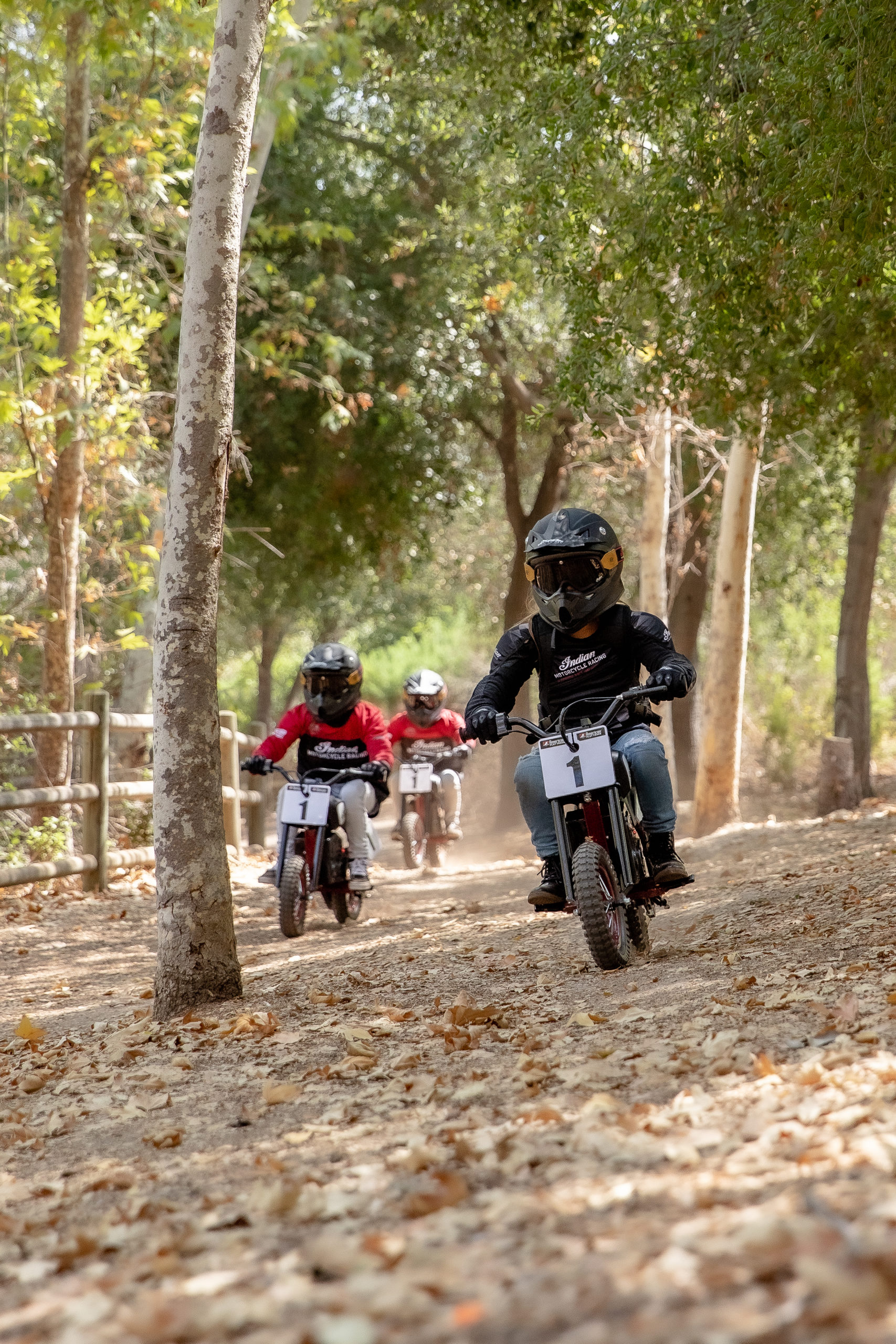 two young riders trying out the new sFTR Mini motorcycles from Indian Motorcycles - an electric-youth bike available to the smaller riding community