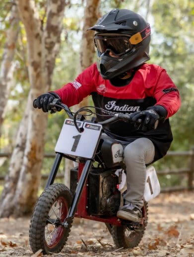 a young rider trying out the new sFTR Mini motorcycle from Indian Motorcycles - an electric-youth bike available to the smaller riding community