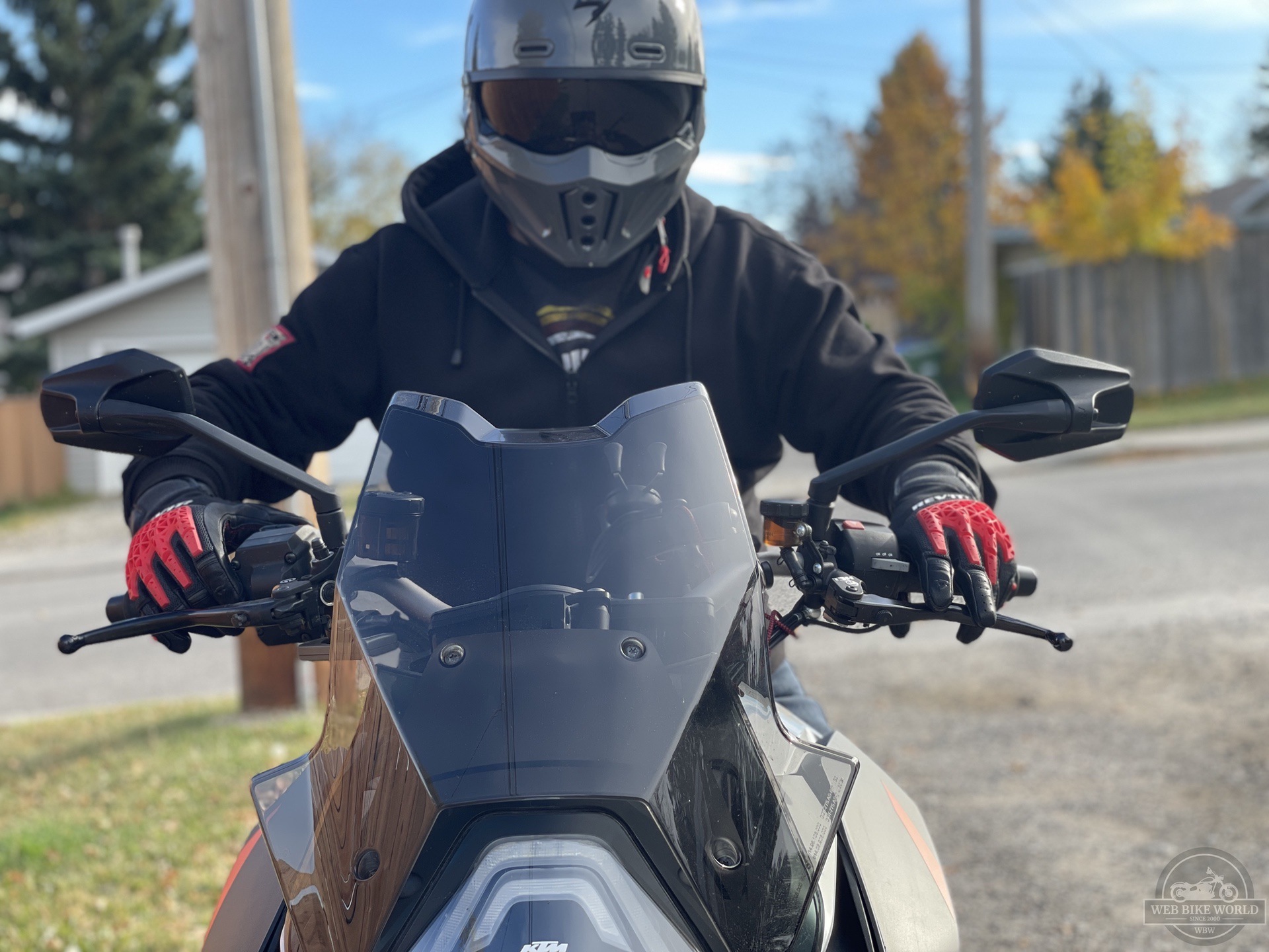 Rider with REV'IT Sand 4 Gloves in black and red with Scorpion Covert X helmet on 2016 KTM Super Duke GT