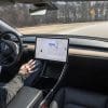 A view of the driving cockpit of a Tesla car, proven to be capable of full autonomy as of 2020
