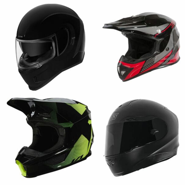 Four motorcycle helmets on white background