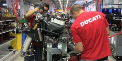 A worker toiling away at a Ducati bike in the creation process