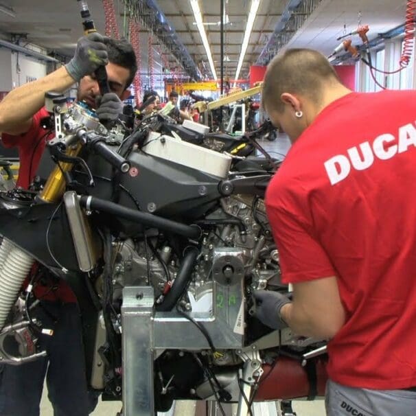 A worker toiling away at a Ducati bike in the creation process