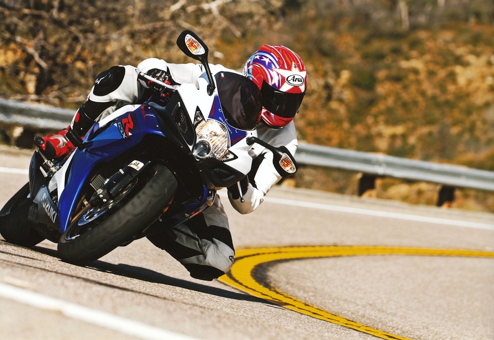 motorcyclist cornering on a road