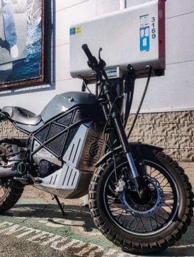 A back view of the ScrAmper - an electric motorcycle from Ukranian brand EMGo, capable of using an electric car charger