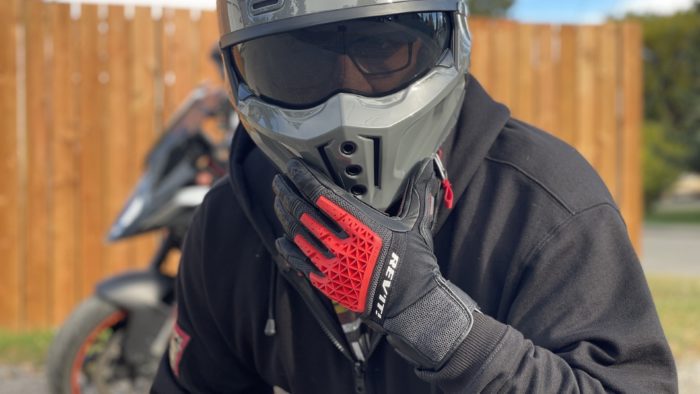 Rider wearing REV'IT Sand 4 Gloves in black and red with Scorpion Covert X helmet Rider wearing REV'IT Sand 4 Gloves in black and red with Scorpion Covert X helmet