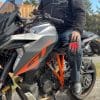 Rider holding Sand 4 Gloves while sitting on motorcycle