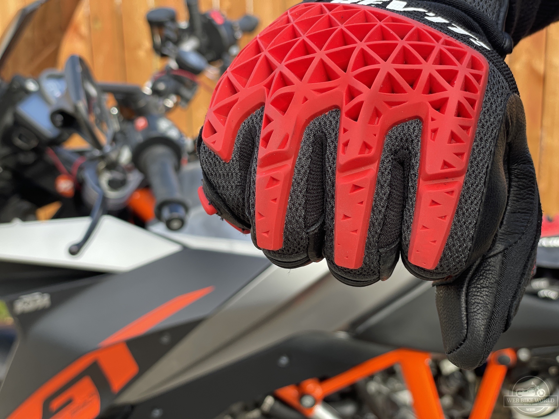 Close-up of red knuckle protectors on red and black REV'IT Sand 4 Gloves