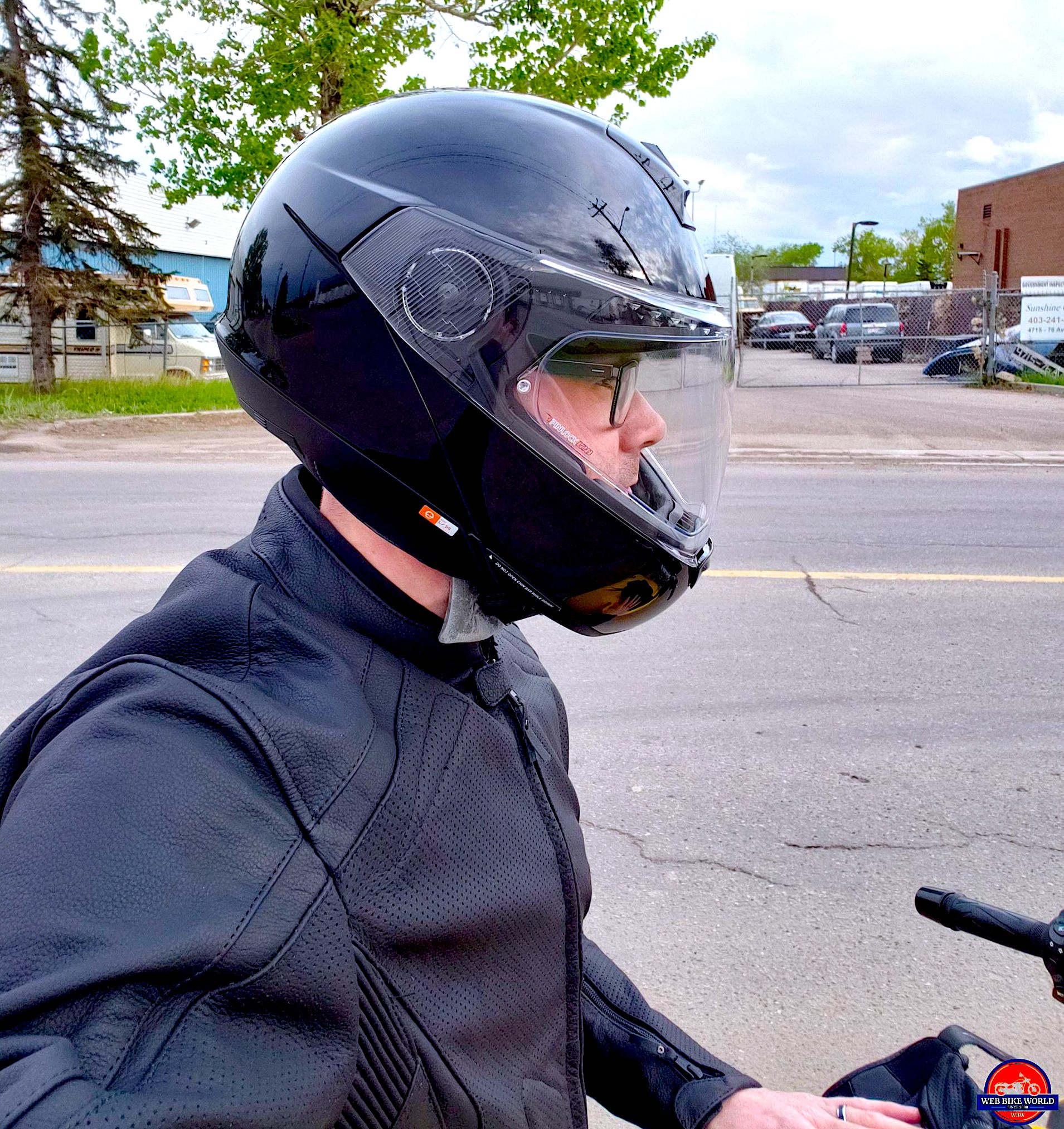 A side view of Cameron Martel trying out the Schuberth C4 Pro helmet in Black