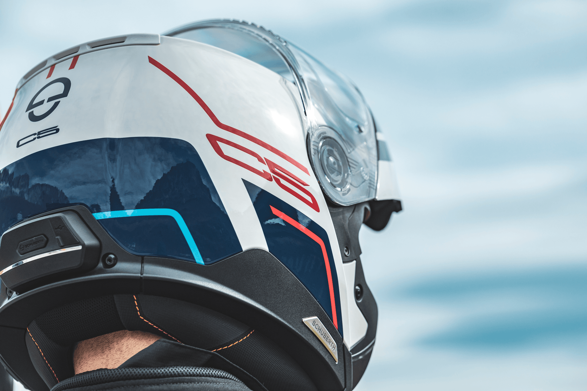 A side view of a model trying on the new C5 helmet from Schuberth