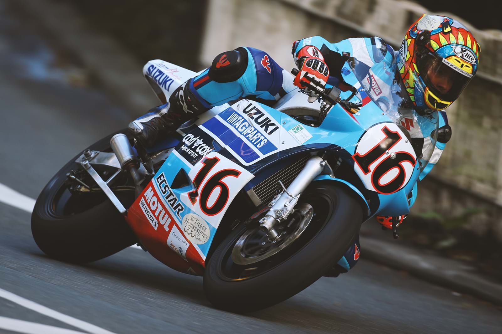 A side view of a racer astride the Suzuki RG500 GP Supersport race bike