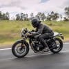 A Thruxton Bonneville Street Cup motorcycle on a quiet road in tasmania