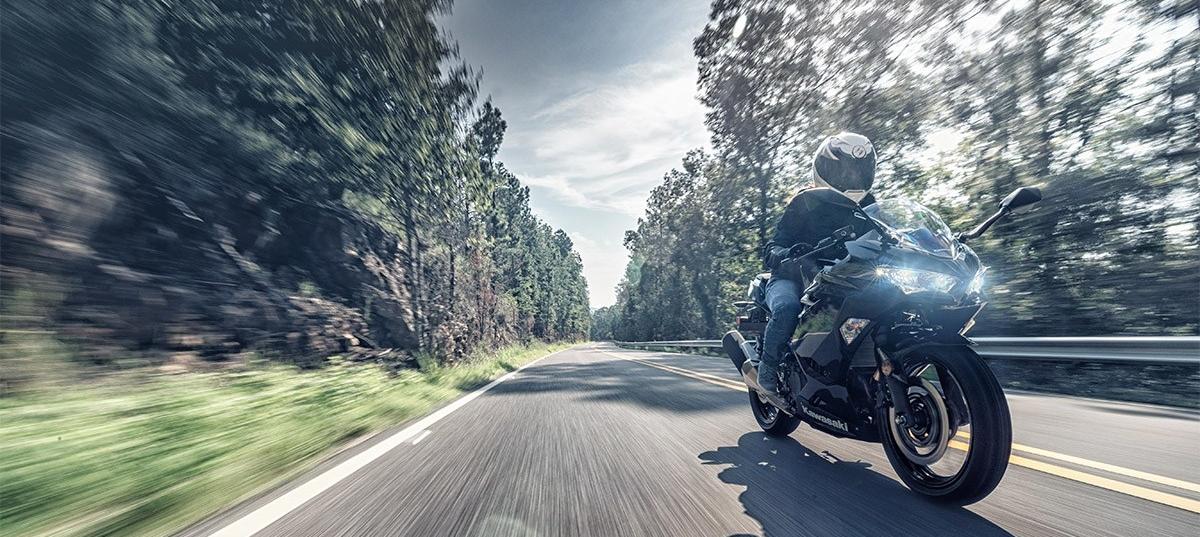 A view of a rider trying out a 2019 ninja motorcycle on some twisties for company advertisement