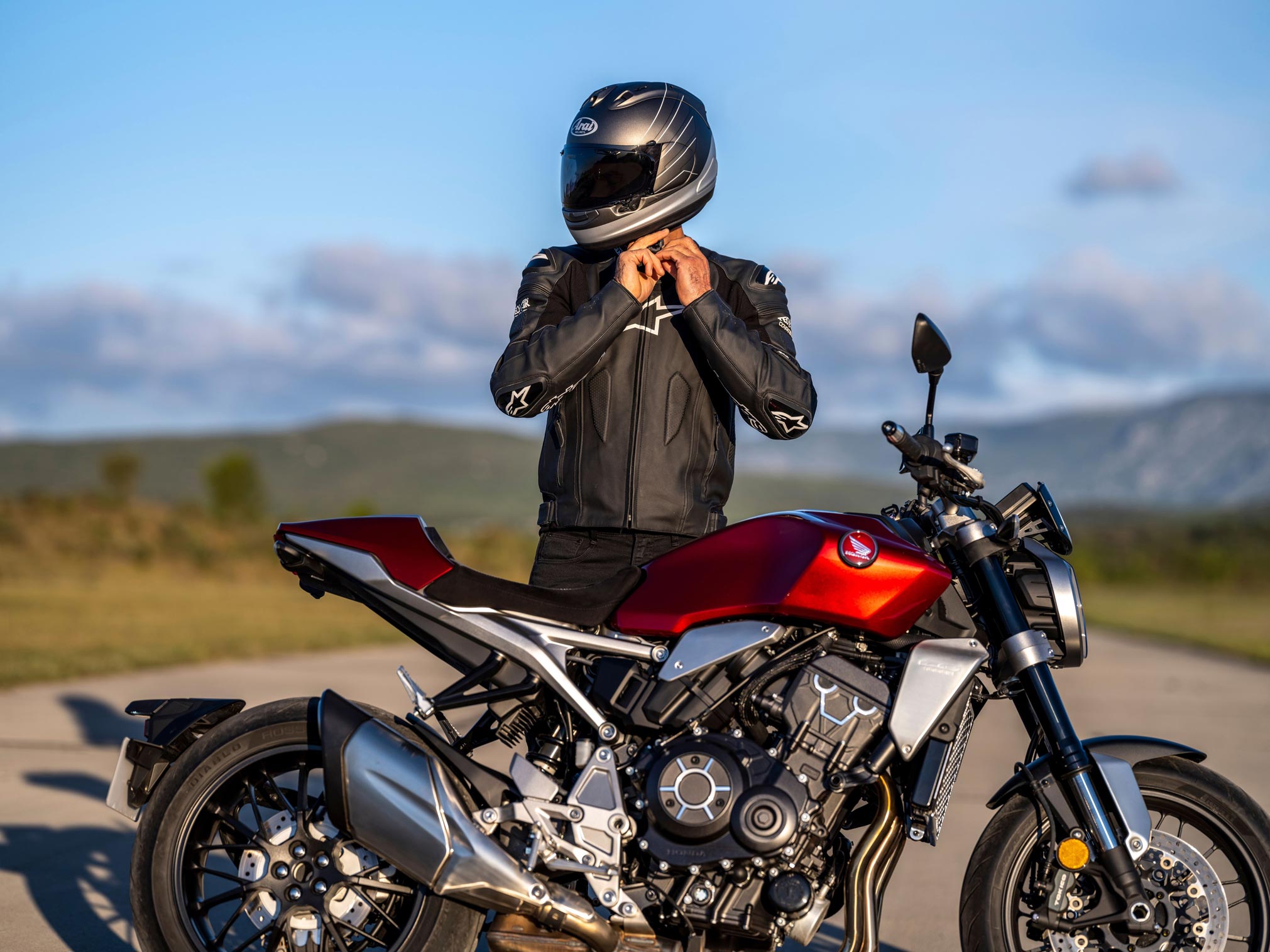 A view of a Honda motorcycle with a rider leaning into the twisties.