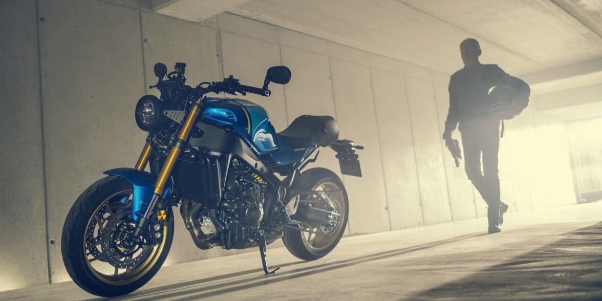 A model posing with the all-new 2022 Yamaha XSR900 - Static images from campaign shoot. Featuring Legend Blue Bike.