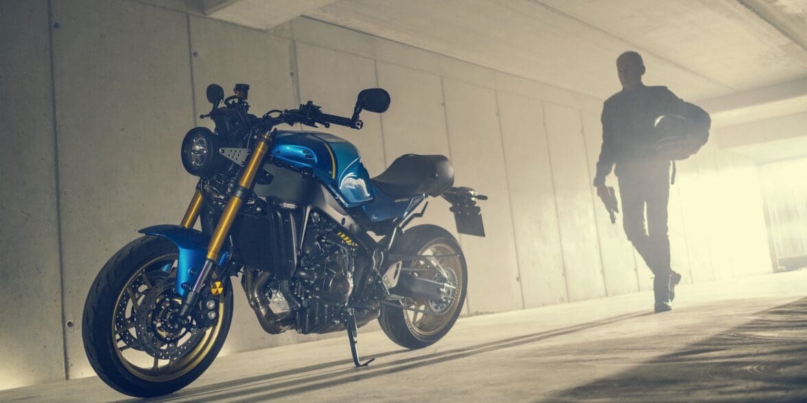 A model posing with the all-new 2022 Yamaha XSR900 - Static images from campaign shoot. Featuring Legend Blue Bike.