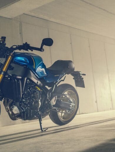 A model posing with the all-new 2022 Yamaha XSR900 - Static images from campaign shoot. Featuring Legend Blue Bike.