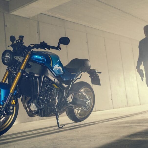 A model posing with the all-new 2022 Yamaha XSR900 - Static images from campaign shoot. Featuring Legend Blue Bike.