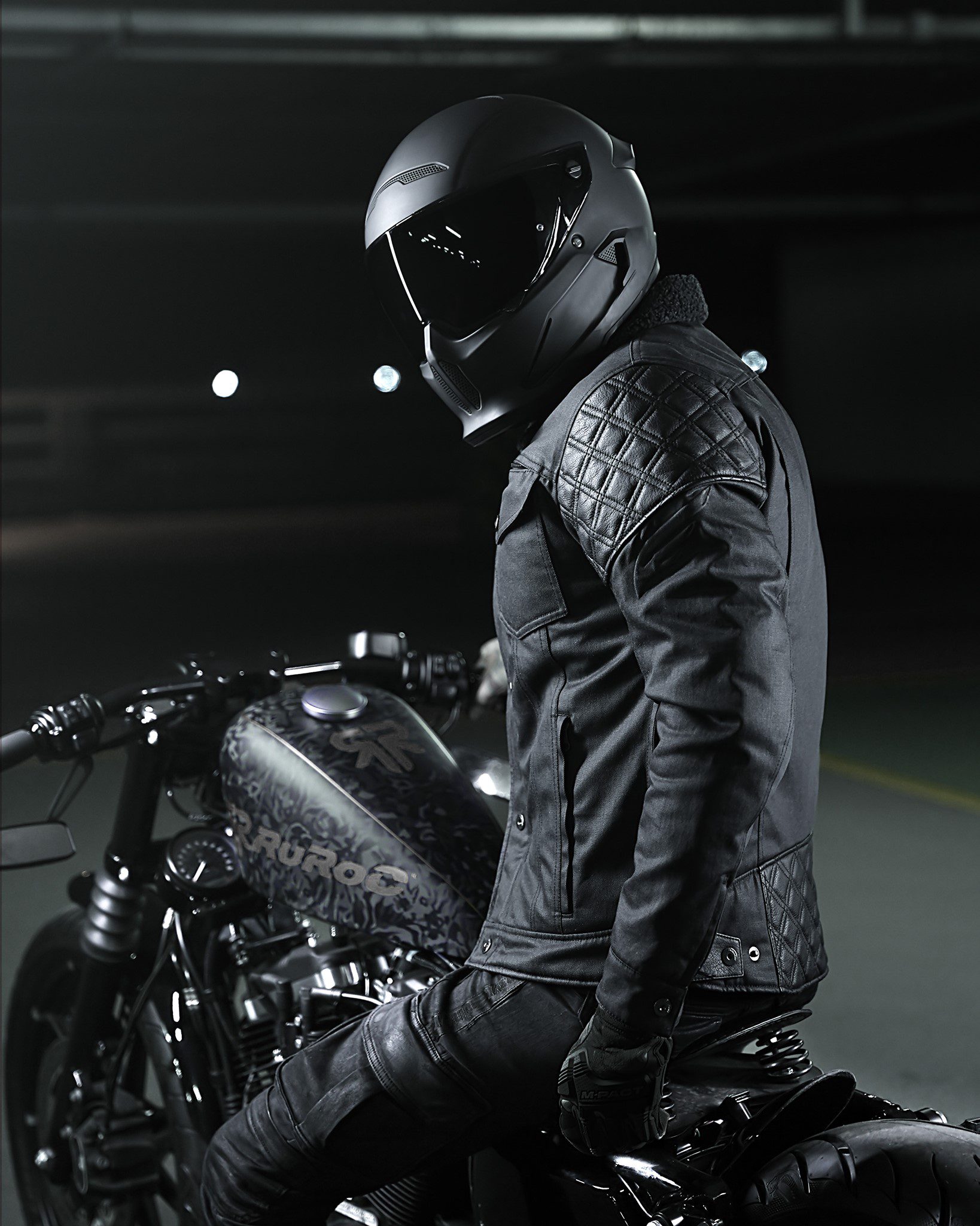 A view of a model wearing the Mother Trucker jacket from Enginehawk and featuring a Ruroc helmet