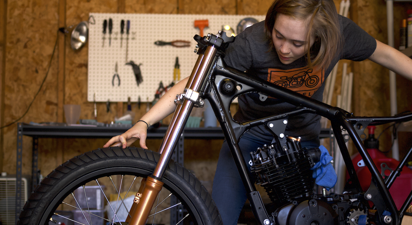 A view of a man working on a motorcycle build