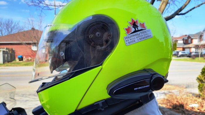 Man wearing bright yellow helmet with Bikecomm BK-S2 attached