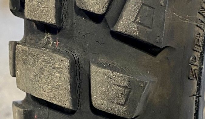 Cracks around the tread blocks of Bridgestone AX41 front tire after 8700kms Cracks around the tread blocks of Bridgestone AX41 front tire after 8700kms