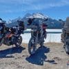 Three motorcycles by frozen mountain lake near Canmore in Alberta