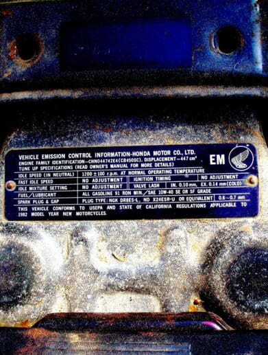 A picture of emissions compliance specs on a Honda motorcycle