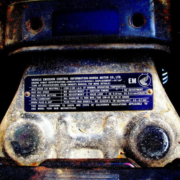 A picture of emissions compliance specs on a Honda motorcycle