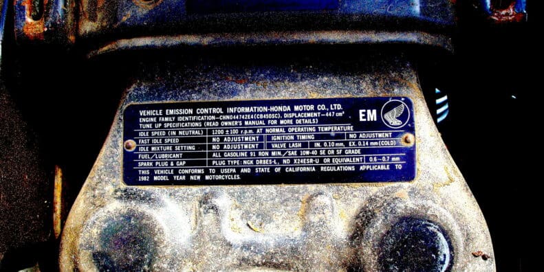 A picture of emissions compliance specs on a Honda motorcycle