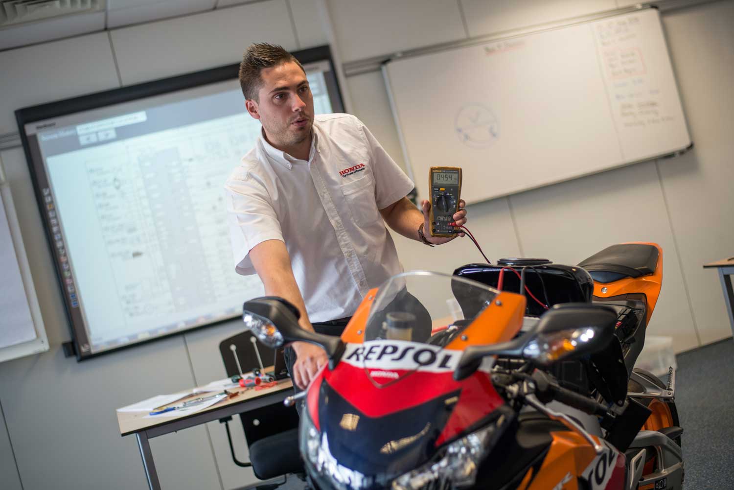 A man showing the spec results after a bike is placed on a dyno