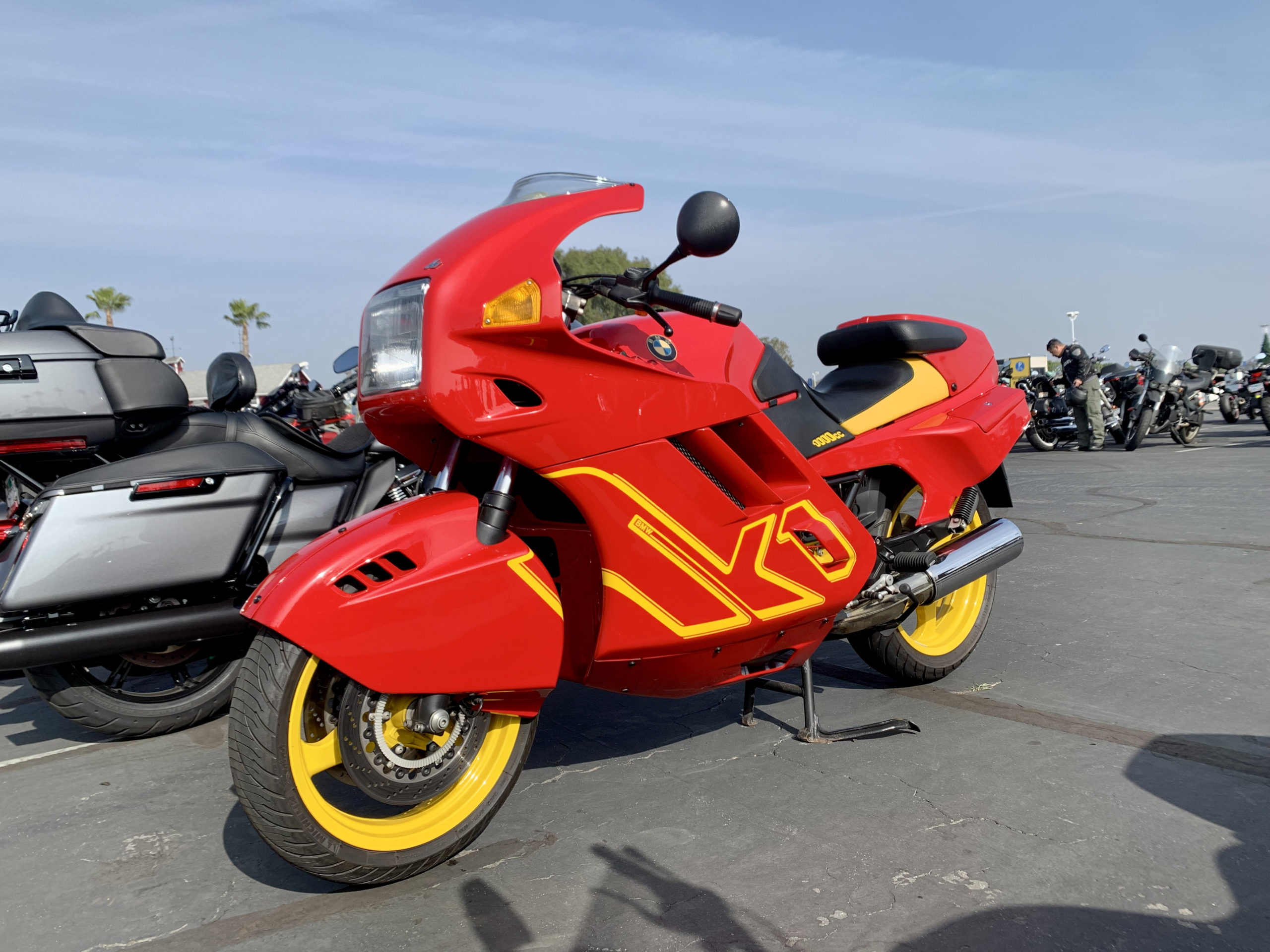 Fully faired red and yellow sport bike parked outdoors for IMS 2021