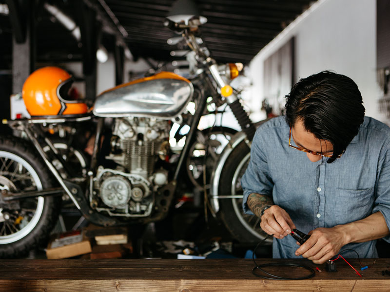 A view of a man working on a motorcycle build