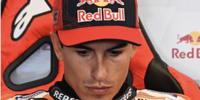 Marc Marquez looks down during a press conference.