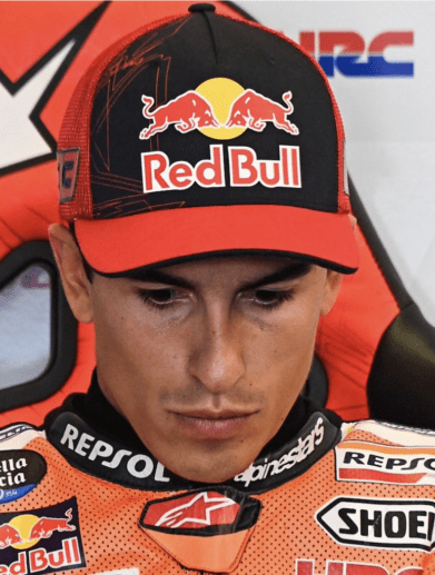 Marc Marquez looks down during a press conference.