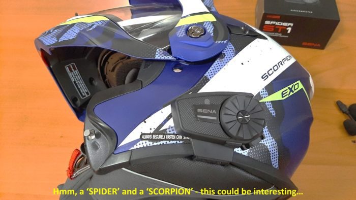 Sena SPIDER ST1 headset in blue Scorpion EXO helmet lying sideways on table Sena SPIDER ST1 headset in blue Scorpion EXO helmet lying sideways on table