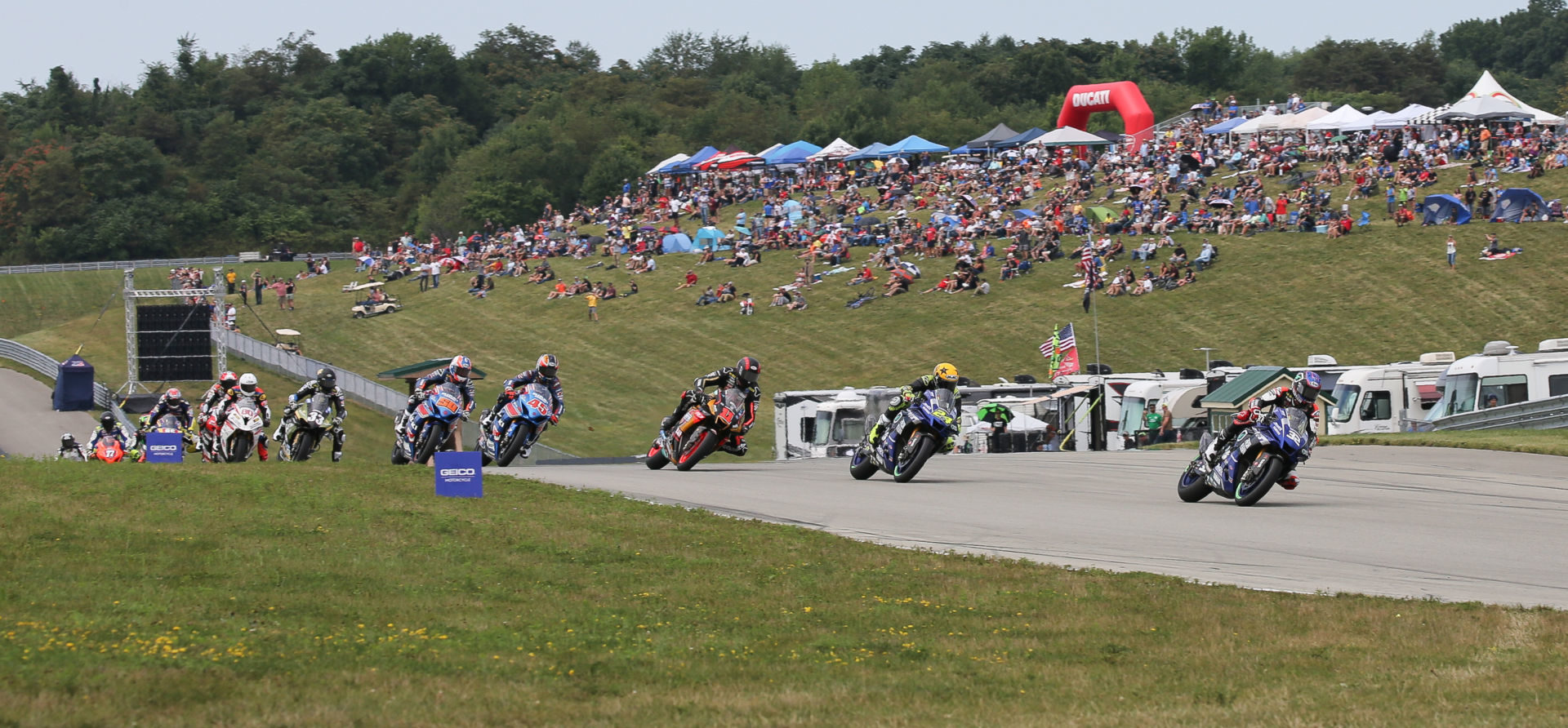 A view of racers speeding through a round of MotoAmerica