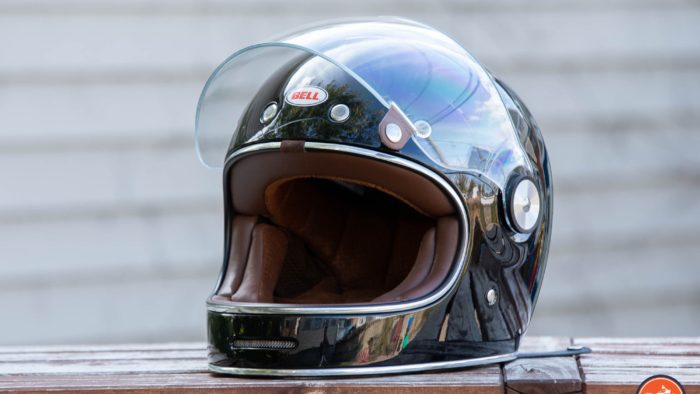 Bell Bullitt Helmet on wooden surface with face shield raised Bell Bullitt Helmet on wooden surface with face shield raised
