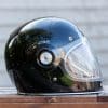 Side view of Bell Bullitt Helmet on wooden surface with face shield lowered