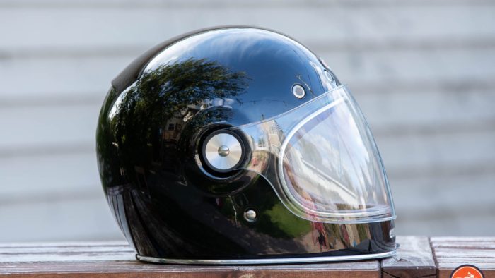 Side view of Bell Bullitt Helmet on wooden surface with face shield lowered Side view of Bell Bullitt Helmet on wooden surface with face shield lowered