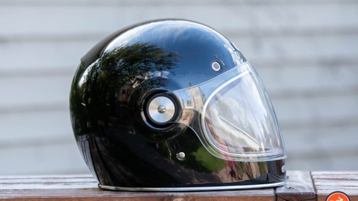 Side view of Bell Bullitt Helmet on wooden surface with face shield lowered