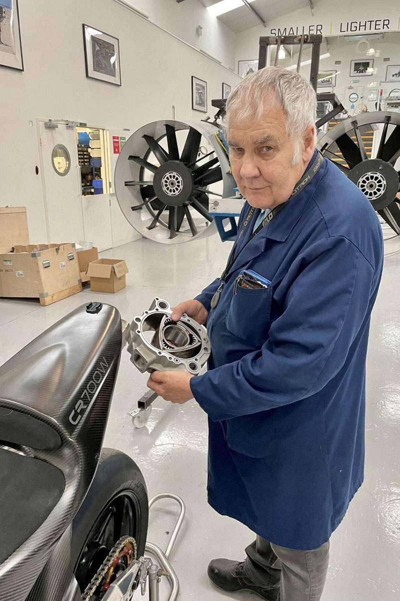A view of Brian Crighton (Crighton Norton) himself holding parts of his new rotary engine in the swanky CR700W: a racebikje designed painstakingly by himself