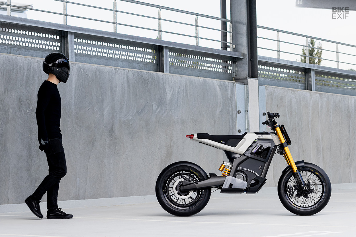 A model walking toward an electric motorcycle from DAB Motors