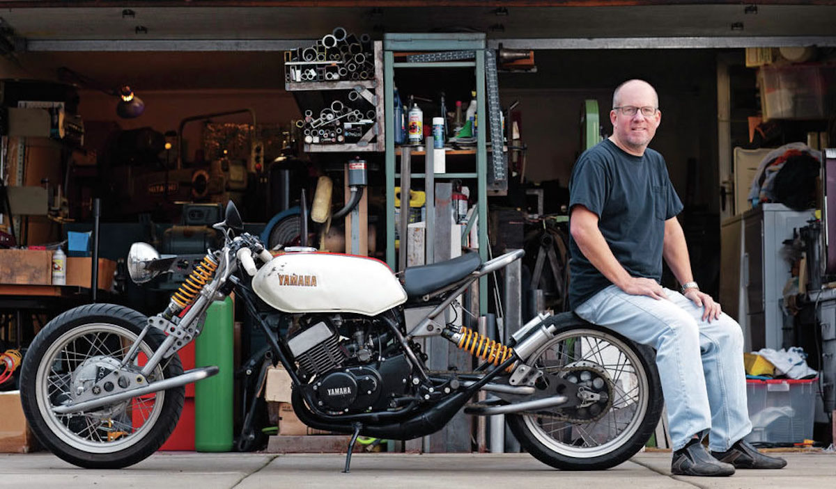 A view of a man working on a motorcycle build