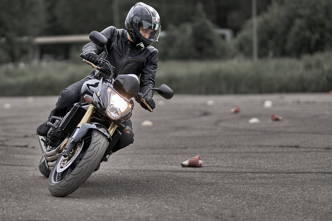 A motorcyclist leaning into the twisties - likely as a learning experience